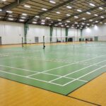 What is the cheap material for a badminton court?