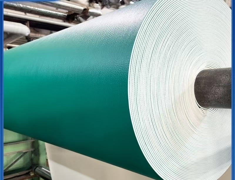Green PVC sports flooring roll on a factory production line